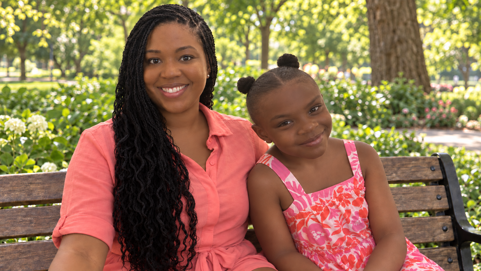 Cherie and Kayleigh smiling together on a park bench